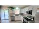 Updated kitchen features granite counters, stainless appliances, and bright white cabinets at 1472 6Th Ave, Deland, FL 32724