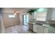 Updated kitchen features granite counters, stainless appliances, and sliding doors to the lanai at 1472 6Th Ave, Deland, FL 32724