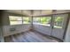 Bright sun room with many windows, white wainscoting and luxury vinyl flooring at 1472 6Th Ave, Deland, FL 32724