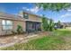 View of the backyard featuring a screened-in patio and lush landscaping at 1523 Casa Park Cir, Winter Springs, FL 32708