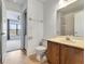Bathroom with vanity and toilet, leading to bedroom with window at 1523 Casa Park Cir, Winter Springs, FL 32708