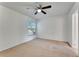 Bedroom boasts a ceiling fan, window for natural light, and neutral carpet at 1523 Casa Park Cir, Winter Springs, FL 32708