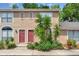 Charming townhouse exterior featuring a red front door and well-maintained landscaping at 1523 Casa Park Cir, Winter Springs, FL 32708