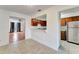 Bright kitchen features a breakfast bar, tile floors, and wood cabinetry at 1523 Casa Park Cir, Winter Springs, FL 32708