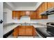 Functional kitchen with wood cabinets, laminate countertops, and essential appliances, ready for meal preparation at 1523 Casa Park Cir, Winter Springs, FL 32708
