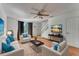 Bright living room with hardwood floors, stylish furniture, and a ceiling fan at 1523 Casa Park Cir, Winter Springs, FL 32708