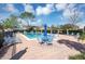 Community pool with lounge chairs and umbrellas on a sunny day at 1523 Casa Park Cir, Winter Springs, FL 32708