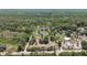 Expansive aerial view of the property, featuring a pond and surrounding lush greenery at 1526 Maytown Rd, Oak Hill, FL 32759