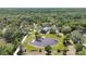 Aerial view of a home by a pond, surrounded by nature at 1526 Maytown Rd, Oak Hill, FL 32759