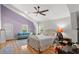 Bright bedroom with a gold bed frame, hardwood floors, and a comfortable sitting area at 1526 Maytown Rd, Oak Hill, FL 32759