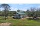 Exterior view with balconies overlooking the lawn, a green roof, and ample space at 1526 Maytown Rd, Oak Hill, FL 32759