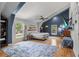 Spacious main bedroom featuring hardwood floors, a large window, and vaulted ceilings at 1526 Maytown Rd, Oak Hill, FL 32759