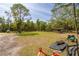 Expansive property with large grassy areas and mature trees on a sunny day at 1526 Maytown Rd, Oak Hill, FL 32759