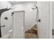 Walk-in shower with stone flooring, modern fixtures, and tiled walls with a decorative mural at 1526 Maytown Rd, Oak Hill, FL 32759