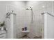 Spacious walk-in shower with white tile, marble accents, and a pebble floor for a luxurious feel at 1526 Maytown Rd, Oak Hill, FL 32759