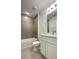 Modern bathroom features a large vanity, modern fixtures, and a tiled shower-tub combination at 1904 Diamond Head Cir, Lake Hamilton, FL 33851