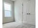 Bright bedroom featuring a window and a closet with double doors at 1904 Diamond Head Cir, Lake Hamilton, FL 33851