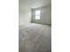 Clean bedroom with neutral carpet and a window offering natural light at 1904 Diamond Head Cir, Lake Hamilton, FL 33851