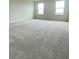 Spacious bedroom with neutral carpet, great natural light from two windows, and room for furnishings at 1904 Diamond Head Cir, Lake Hamilton, FL 33851