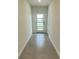 Bright foyer featuring neutral tiling and a glass-paneled front door allowing natural light to flood the space at 1904 Diamond Head Cir, Lake Hamilton, FL 33851