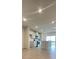 Open-concept kitchen with stainless steel appliances, an island with a sink, and sliding glass doors at 1904 Diamond Head Cir, Lake Hamilton, FL 33851