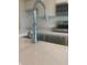 Close up of the kitchen sink, featuring modern faucet fixtures and a quartz countertop at 1904 Diamond Head Cir, Lake Hamilton, FL 33851