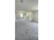 Upstairs loft area featuring neutral carpeting and a staircase at 1904 Diamond Head Cir, Lake Hamilton, FL 33851