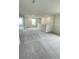 Spacious loft area with neutral carpet, bright natural light, and great for additional living space at 1904 Diamond Head Cir, Lake Hamilton, FL 33851
