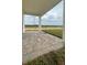View of the covered patio with brick flooring, perfect for outdoor seating and relaxation at 1904 Diamond Head Cir, Lake Hamilton, FL 33851
