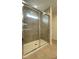Modern shower with glass door and gray tiling at 1904 Diamond Head Cir, Lake Hamilton, FL 33851
