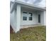 Back porch features a covered patio, brick flooring, and a door to the house at 1908 Diamond Head Cir, Lake Hamilton, FL 33851
