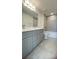 Modern bathroom featuring double vanity, gray cabinets, sleek fixtures, and a shower-tub combination at 1908 Diamond Head Cir, Lake Hamilton, FL 33851