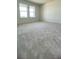 Bedroom featuring neutral carpeting and a pair of bright windows at 1908 Diamond Head Cir, Lake Hamilton, FL 33851
