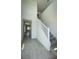 Hallway and staircase featuring tile flooring and a view to the outside at 1908 Diamond Head Cir, Lake Hamilton, FL 33851