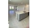 Open-concept kitchen featuring an island with light countertops and modern grey cabinets at 1908 Diamond Head Cir, Lake Hamilton, FL 33851