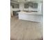 Kitchen featuring an island with light countertops, modern grey cabinets, and stainless steel sink at 1908 Diamond Head Cir, Lake Hamilton, FL 33851