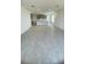 Open-concept living room featuring neutral tile flooring and seamlessly connected to the kitchen at 1908 Diamond Head Cir, Lake Hamilton, FL 33851