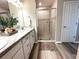 Well-lit bathroom featuring marble countertops, neutral decor, and glass shower door at 2000 Golden Beak Dr, Eagle Lake, FL 33839