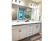 Bright bathroom featuring double vanity with marble countertops and modern fixtures at 2000 Golden Beak Dr, Eagle Lake, FL 33839