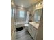Bathroom with tub and shower featuring tile surround, and neutral color palette at 2000 Golden Beak Dr, Eagle Lake, FL 33839