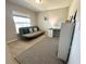 Neutral bedroom with futon, desk, and patterned rug at 2000 Golden Beak Dr, Eagle Lake, FL 33839