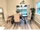 Dining area with neutral decor, wood-look floors, and views of the outdoors at 2000 Golden Beak Dr, Eagle Lake, FL 33839