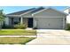 Charming single-Gathering home featuring a two-car garage and well-maintained lawn at 2000 Golden Beak Dr, Eagle Lake, FL 33839