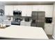 Well-equipped kitchen featuring white cabinets, stainless steel appliances, and solid surface countertops at 2000 Golden Beak Dr, Eagle Lake, FL 33839