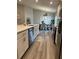 Bright eat-in kitchen features stainless appliances, island with quartz countertops, and dining area at 2000 Golden Beak Dr, Eagle Lake, FL 33839