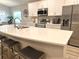Bright kitchen featuring white cabinets, stainless steel appliances, and a large peninsula at 2000 Golden Beak Dr, Eagle Lake, FL 33839