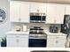 Updated kitchen with white cabinets, stainless steel appliances, and modern countertops at 2000 Golden Beak Dr, Eagle Lake, FL 33839