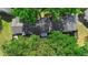 Bird's eye view of a home's roof and backyard, surrounded by mature trees and lush greenery at 2808 Revere Ct, Casselberry, FL 32707
