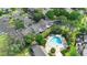 Inviting community pool with lounge chairs, surrounded by lush landscaping and well-maintained buildings at 2808 Revere Ct, Casselberry, FL 32707