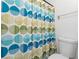 Bathroom featuring toilet and shower stall with a blue, green and yellow patterned curtain at 2808 Revere Ct, Casselberry, FL 32707